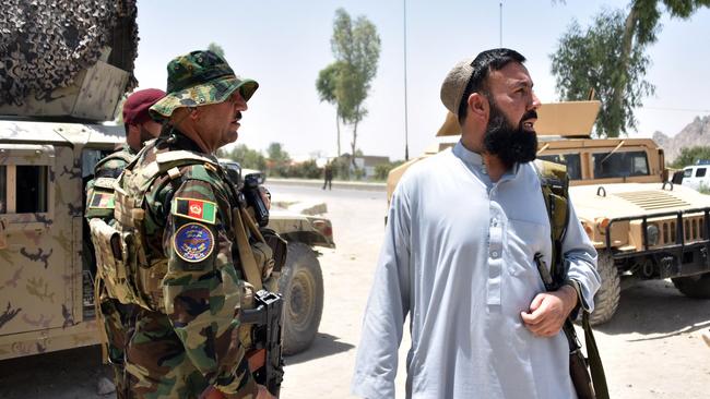 Afghan security personnel stand guard along the road amid ongoing fight between Afghan security forces and Taliban fighters in Kandahar on the weekend. Picture: AFP