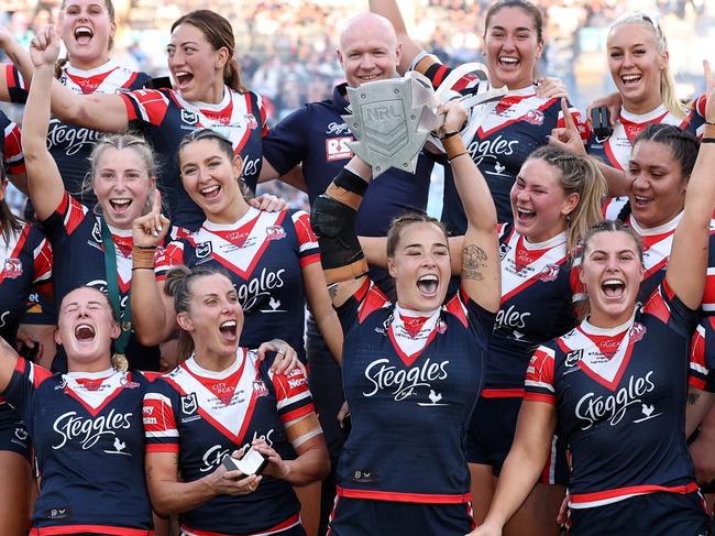 SYDNEY, AUSTRALIA - OCTOBER 06:  Roosters players celebrate with the NRL Women's Premiership Trophy after winning the NRLW Grand Final match between Sydney Roosters and Cronulla Sharks at Accor Stadium on October 06, 2024, in Sydney, Australia. (Photo by Cameron Spencer/Getty Images)