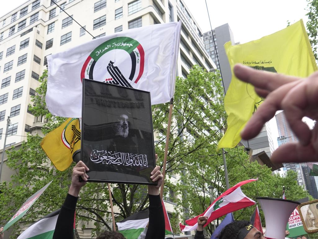 Protesters carry s picture of assassinated Hezbollah leader Hassan Nasrallah. Picture: Valeriu Campan