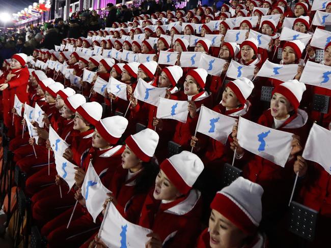 Members of the North Korean delegation hold flags of the combined Koreas. Picture: AP Photo/Matthias Schrader