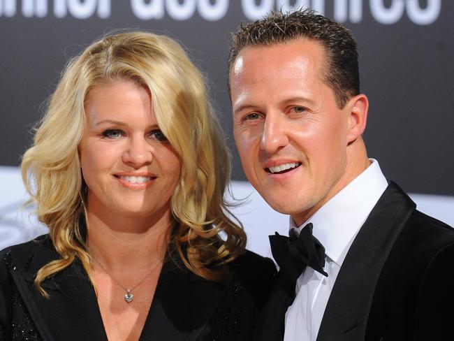 Formula-One driver Michael Schumacher and his wife Corinna arrive for the GQ gala 'Men of the Year' in Berlin on October 29, 2010.  AFP PHOTO / JENS KALAENE  GERMANY OUT / AFP PHOTO / DPA / JENS KALAENE