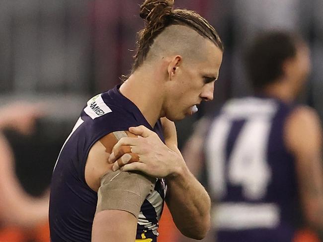 PERTH, AUSTRALIA - JULY 15: Nat Fyfe of the Dockers holds his injured shoulder during the round 18 AFL match between the Fremantle Dockers and Geelong Cats at Optus Stadium on July 15, 2021 in Perth, Australia. (Photo by Paul Kane/Getty Images)