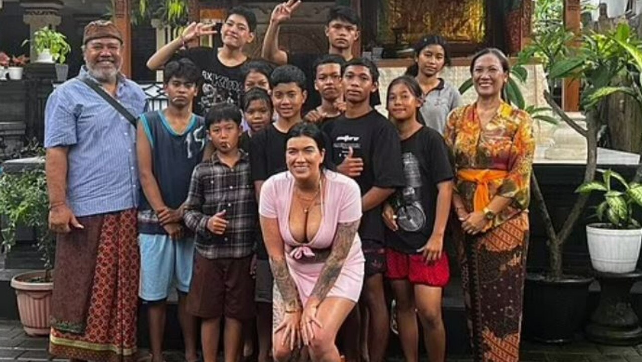 Ms Foster poses with children in Bali. Picture: Facebook