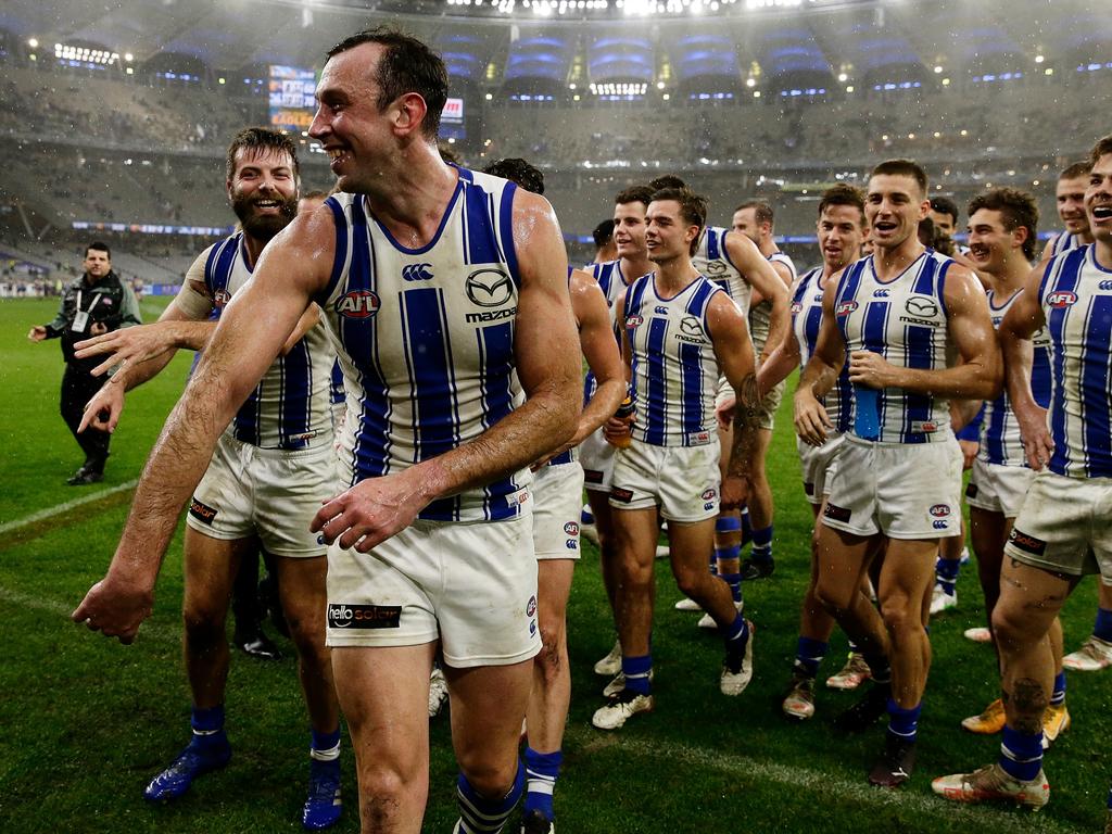 Todd Goldstein leads the Roos off after a record-breaking performance in the win. Picture: AFL Photos/Getty Images