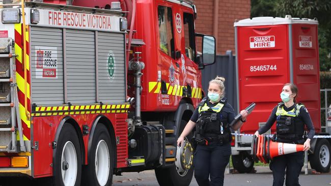 Police and firefighters at the scene where a woman and three children were killed in a house fire at Glen Waverley. Picture: David Crosling