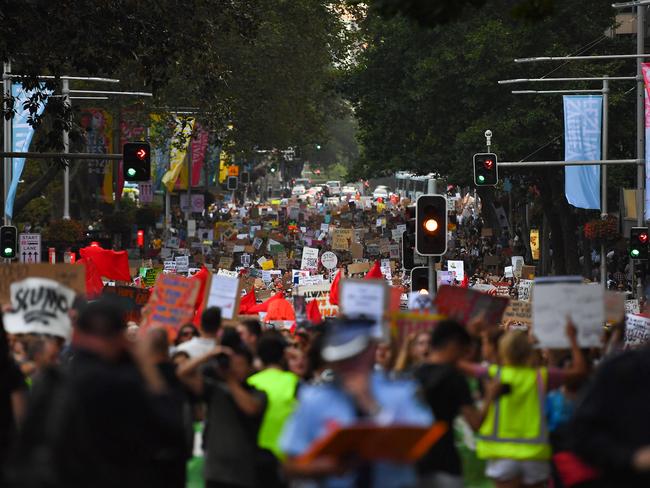 Protesters march with placards during a 'Sack ScoMo!' climate change rally in Sydney on Friday, January 10. Picture: AAP/Steven Saphore