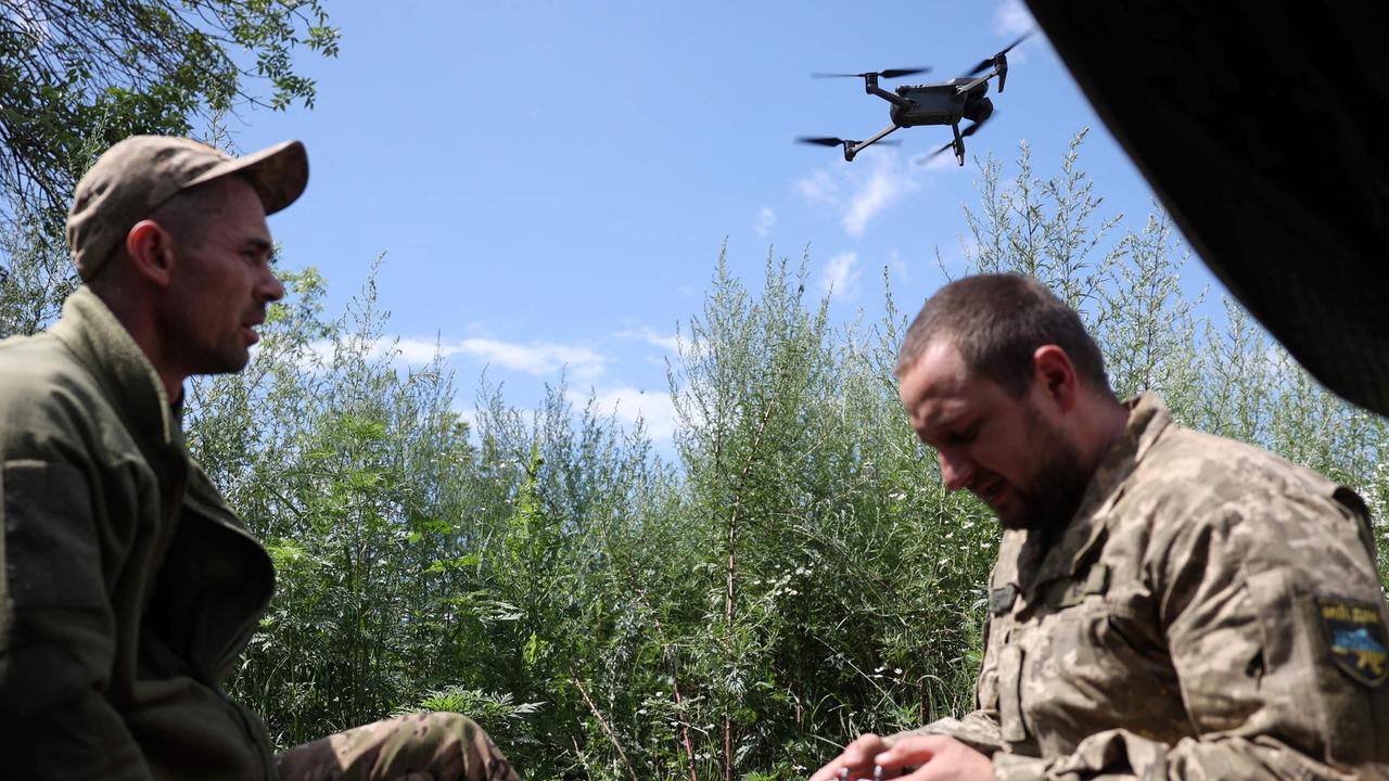 Ukrainian servicemen from the K-2 battalion fly a drone at a frontline position.