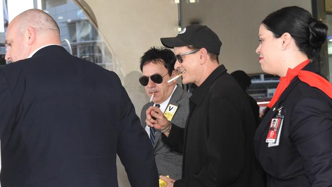 It didn’t take long for Charlie Sheen to have a dart with celebrity manager Ralph Carr. Picture: Tony Gough