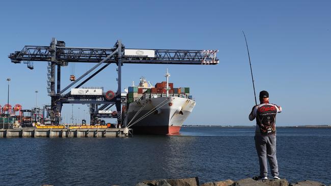 A container ship is unloaded at Port Botany in Sydney. The cost of a 40-foot shipping container has increased by around 200 per cent in a year. Picture: Brett Costello