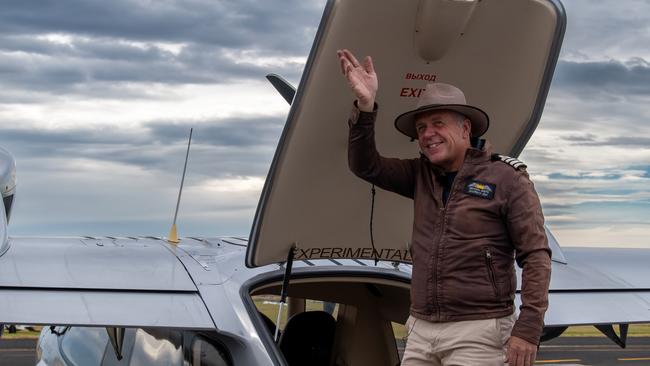 Michael Smith waves from the hatch of his plane before he sets off to recreate the first circumnavigation by air of Australia. Picture: Supplied/ Defence/ Cpl Michael Currie