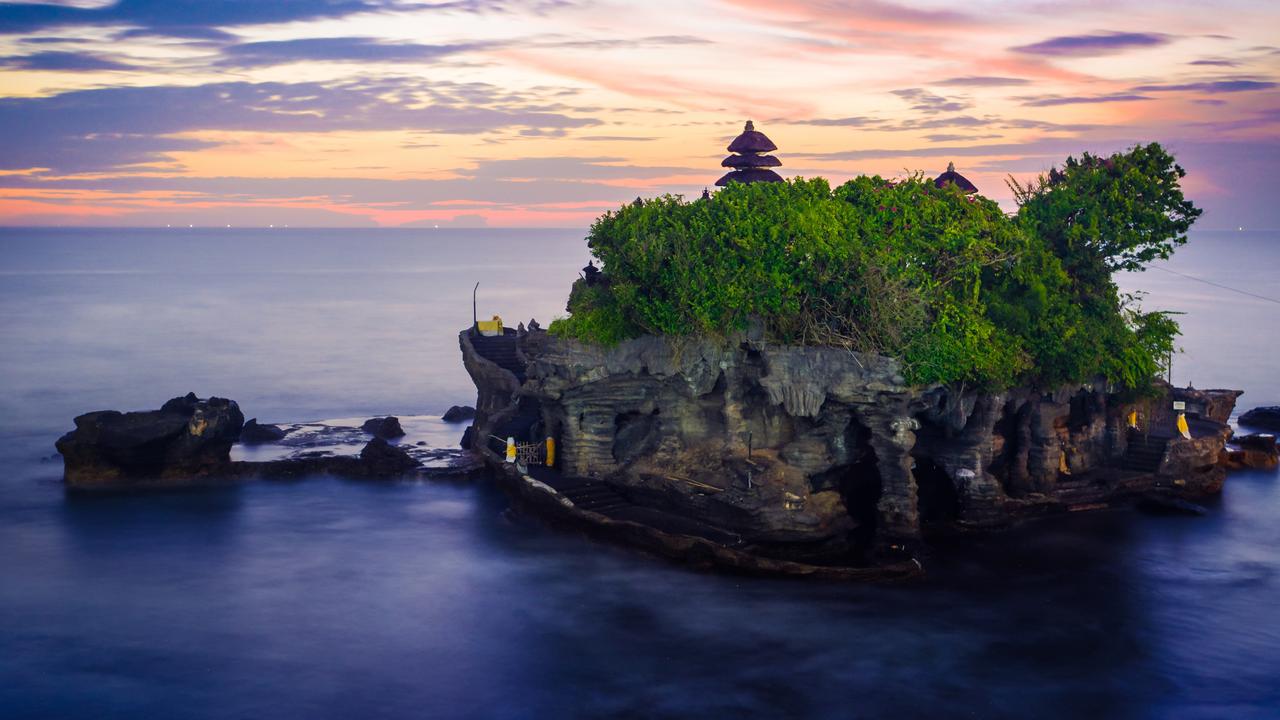 Tanah Lot Temple is known for being a popular photo spot among tourists and can only be accessed on low tide. Picture: iStock