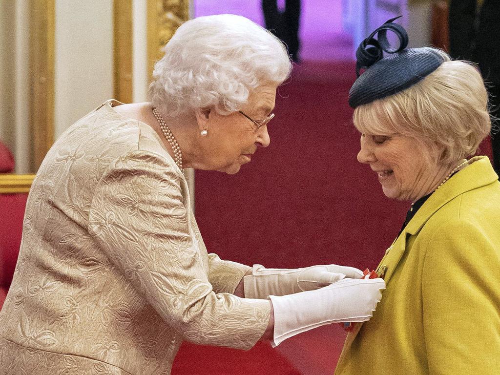 The Queen wore gloves during a ceremony at Buckingham Palace, reportedly to protect herself against the coronavirus outbreak. Picture: AP