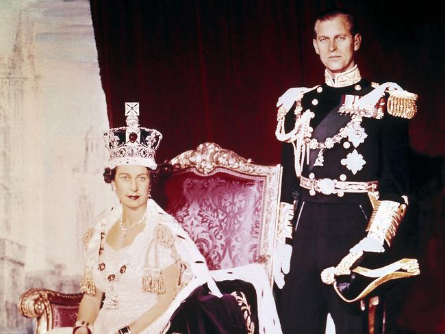 The Queen and Prince Philip pose for an official portrait in Buckingham Palace after the Coronation. The Queen’s velvet robe was edged with ermine and heavily embroidered in gold – elaborate detailing that took a team of 12 seamstresses 3500 hours to complete. Picture: AFP