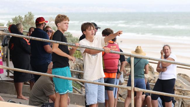 Beachgoers look for a suspected missing person at Henley Beach on Monday. Picture: Russell Millard Photography