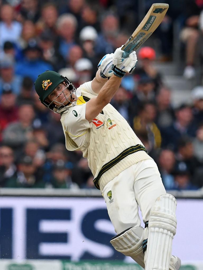 Steve Smith launches an inside out six after a quick dance down the wicket.