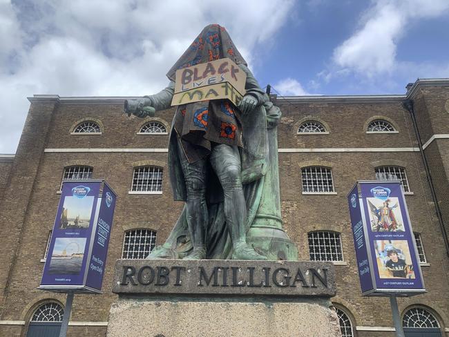 The statue of Robert Milligan, a noted West Indian merchant, slaveholder and founder of London's global trade hub, West India Docks, stands covered in a sackcloth and sign reading Black Lives Matter, outside the Museum of London Docklands. Picture: AP