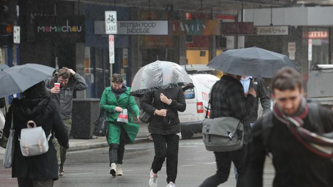 Wet and Windy weather on King William street, Adelaide on Friday. Picture: Michael Marschall