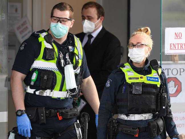 Police leave the Epping Gardens aged care facility in the Melbourne suburb of Epping on July 29, 2020, as the city battles fresh outbreaks of the COVID-19 coronavirus. (Photo by William WEST / AFP)