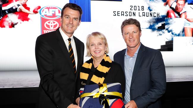 Tigers CEO Brendon Gale, Tigers President Peggy O'Neal and Tigers Senior Coach Damien Hardwick pose for a photograph with the 2017 flag during the 2018 Toyota AFL Premiership Season Launch