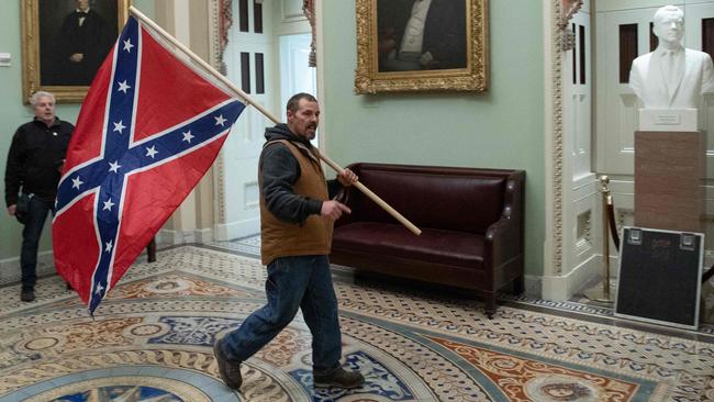 A Trump supporter carries a Confederate flag in the US Capitol Rotunda. Picture: AFP.