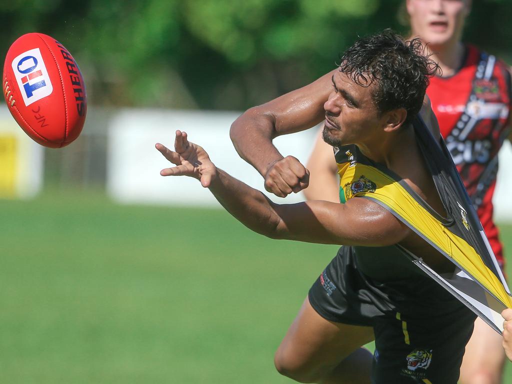 Michael Mummery avoids Samuel De Sousa as Nightcliff trounce the Tiwi Bombers at Nightcliff Oval Picture: Glenn Campbell