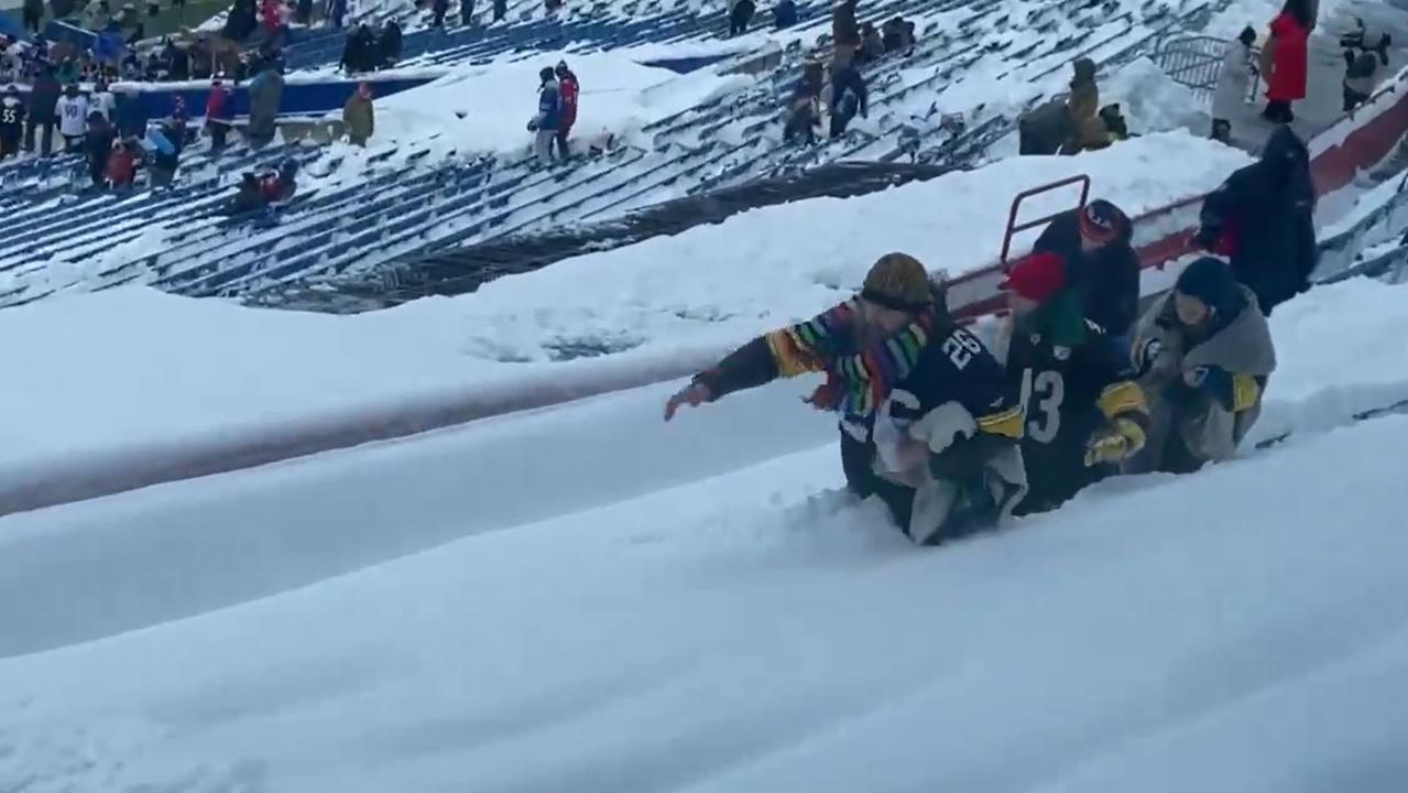 A family of Steelers fans fights their way to a seat.