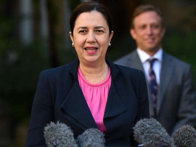 Queensland Premier Annastacia Palaszczuk, flanked by Health Minister Steven Miles, is seen during a press conference at Parliament House in Brisbane, Wednesday, April 22, 2020. Queensland has recorded no new cases of coronavirus in the past 24 hours. (AAP Image/Dan Peled) NO ARCHIVING