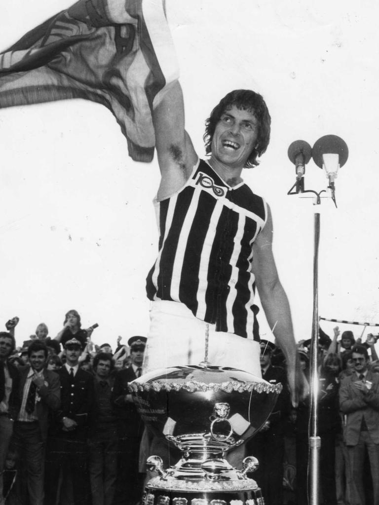 Russell Ebert proudly holds the premiership pennant after Port Adelaide beat Glenelg in the 1977 SANFL grand final.