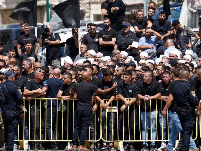 Israeli security hold back demonstrators during a visit by the Israeli Prime Minister two days after a rocket crashed killing 12 youngsters in the Druze village of Majdal Shams in the Israeli annexed Golan Heights. Picture: AFP