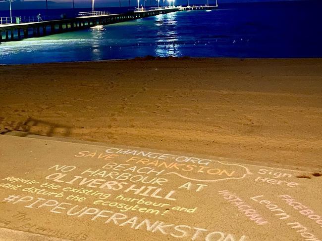 Protests against a possible boat harbour at Olivers Hill were written in chalk near Frankston pier. Picture: supplied