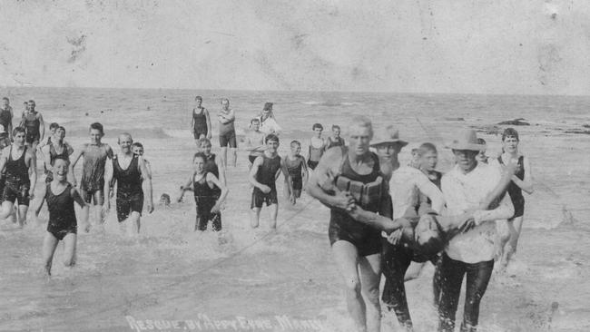 Edward Eyre and two other men bring a 'patient' ashore after a mock rescue. Picture Northern Beaches Library