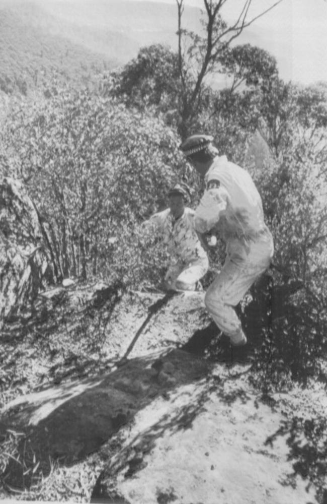 Police at the scene in 1981 where the body of Kim Barry was found at the bottom of a cliff.