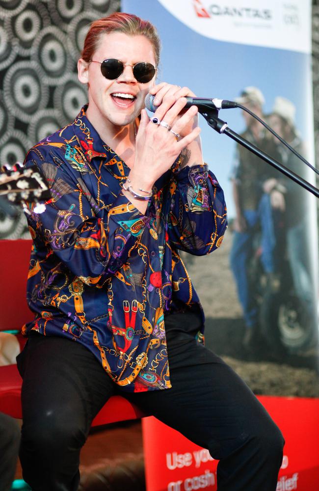 Conrad Sewell performs his hits for Qantas passengers at Sydney airport heading to the Hay Mate concert in Tamworth today. Picture: Luke Drew