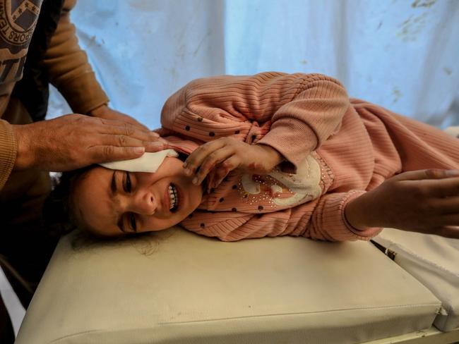 \\KHAN YUNIS, GAZA - DECEMBER 6: (EDITORS NOTE: Image depicts graphic content) A Palestinian child injured in an Israeli airstrike receives treatment at Nasser Medical Hospital on December 06, 2023 in Khan Yunis, Gaza. Israel stepped up its military operations in Gaza after a sustained truce between Hamas and Israel did not hold further than a week despite diplomatic talks and captives released. (Photo by Ahmad Hasaballah/Getty Images)