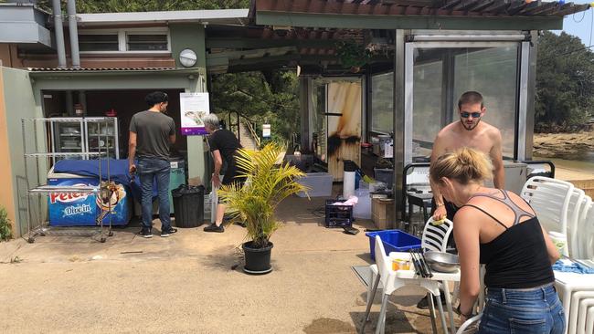 Carly Nicol has chosen not to renew the lease on the Little Manly Beach Kiosk. Workers help clean furniture and fittings that are now up for sale. Picture: Jim O'Rourke