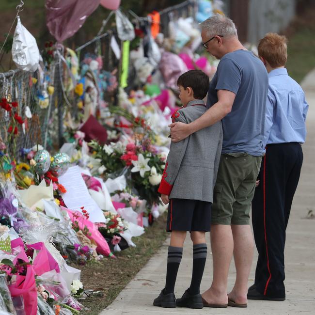 School friends of Antony, brothers Jude and Quinn with their father Scott Lattimar on Tuesday. Picture: John Grainger