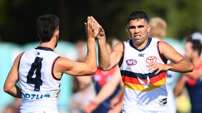 MELBOURNE, AUSTRALIA - FEBRUARY 22: Tyson Stengle of the Crows is congratulated by team mates after kicking a goal during the 2020 Marsh Community AFL Series match between the Melbourne Demons and the Adelaide Crows at Casey Fields on February 22, 2020 in Melbourne, Australia. (Photo by Quinn Rooney/Getty Images)