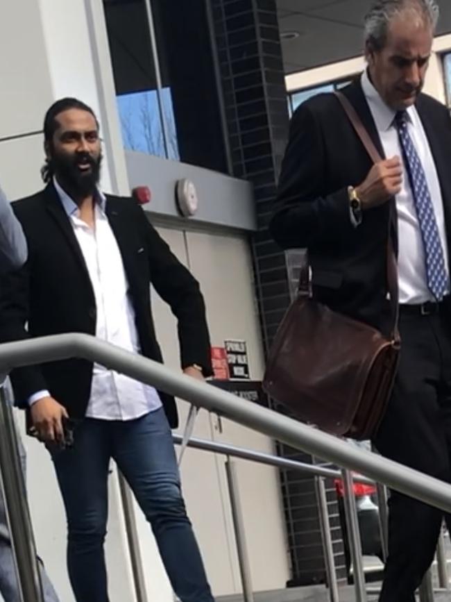 Canberra man Faizan Ahmed (left) with defence representative Derek Drewett.