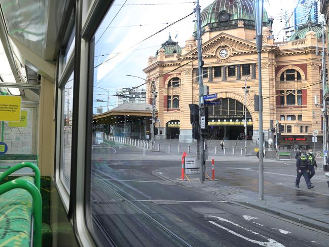 MELBOURNE, AUSTRALIA - NewsWire Photos AUGUST 6, 2020: An empty tram goes past Flinders Street Station in Swanston Street during day one of the stage four lockdown in Melbourne where people must have a work permit to be out on the roads. Picture: NCA NewsWire / David Crosling