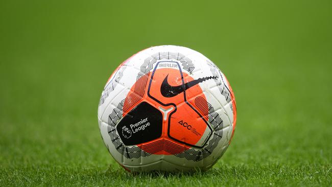 The logo of the English Premier League is pictured on a match ball. Photo by Joe Giddens / POOL / AFP.