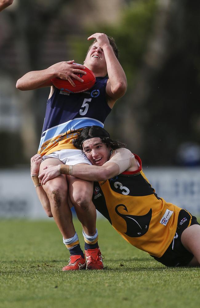 Gotcha: Dandenong Stingray Jamie Plumridge brings down Pioneers Noah Wheeler.