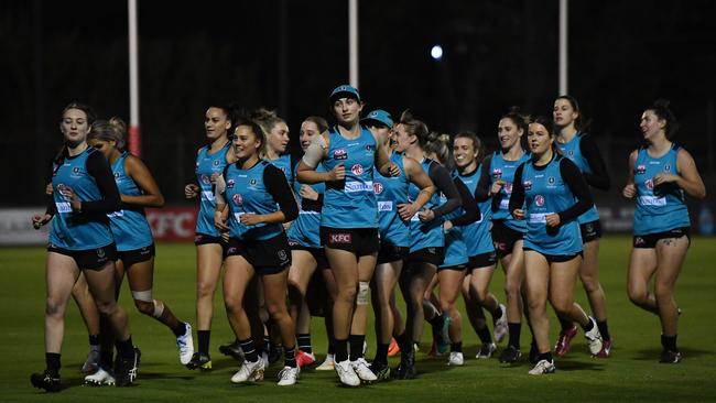 Players warm-up during the first AFLW Port Adelaide training session at Alberton Oval. Picture: Mark Brake