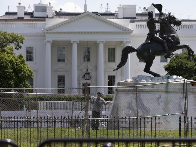 The base of the statue of former president Andrew Jackson is power washed inside a newly closed Lafayette Park, Wednesday, June 24, 2020, in Washington, which has been the site of protests over the death of George Floyd, a black man who was in police custody in Minneapolis. Floyd died after being restrained by Minneapolis police officers. (AP Photo/Jacquelyn Martin)