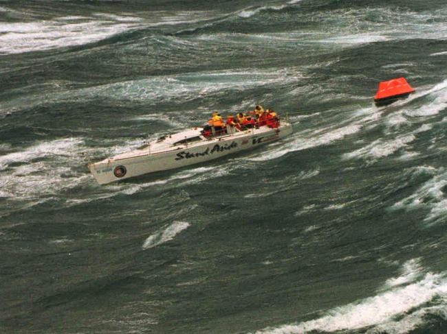 Injured crew of dismasted yacht Stand Aside waiting to be rescued in Bass Strait.