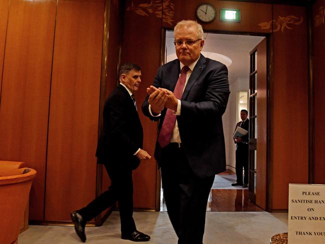 CANBERRA, AUSTRALIA - MARCH 20: Prime Minister Scott Morrison and Chief Medical Officer for the Australian Government Professor Brendan Murphy sanitise their hands on arrival for a National Cabinet meeting at Parliament House on March 20, 2020 in Canberra, Australia. Further restrictions on indoor gatherings are expected to be announced today in response to the ongoing COVID-19 pandemic. Currently non-essential gatherings of 100 or more people indoors are banned, along with outdoor gatherings of more than 500. Prime Minister Scott Morrison on Thursday announced Australia would be closing its borders to all visitors for six months. The travel ban will be placed on all people who are not Australian residents or their direct relations coming to the country from 9pm on Friday night.  There are now 709 confirmed cases of COVID-19 In Australia while the death toll now stands at seven.  (Photo by Sam Mooy/Getty Images)