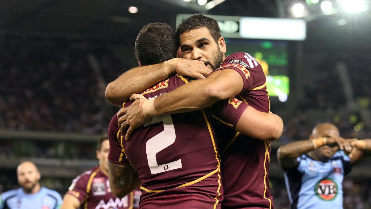 Darius Boyd gets a hug from Greg Inglis after scoring a try for the Maroons.