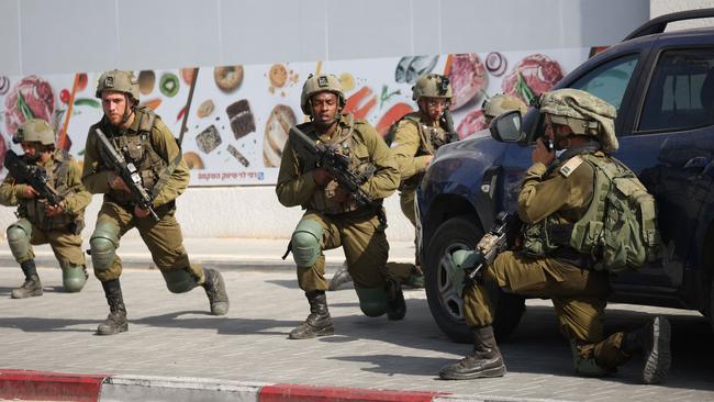 Israeli soldiers deploy in an area where civilians were killed in the southern city of Sderot. Picture: AFP