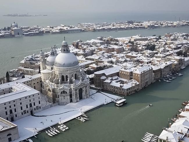 In this aerial image taken Wednesday, Feb. 28, 2018, the Santa Maria della Salute Basilica (Saint Mary of Health) on the Grand Canal in Venice, northern Italy, is covered by a blanket of snow as freezing weather from a Siberian cold snap persists in large part of the country. Picture: AP