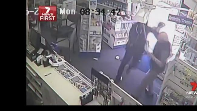 Still from CCTV video of a cleaner bravely confronting raiders at a Nerang pharmacy. Picture: 7News