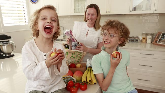 Fiona Franz unpacking groceries with her sons Saxon, 8, and Lincoln, 6. She says she’d happily buy local but sometimes it isn’t easy to tell what comes from overseas. Picture: Tim Hunter